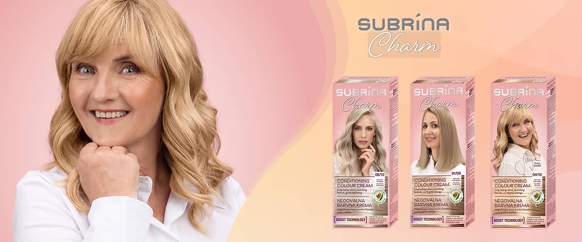 Ženska z blond lasmi, nasmejana s podprtko brade in škatle barv za lase znamke Subrina Charm, embalaže z ženskami in logotip