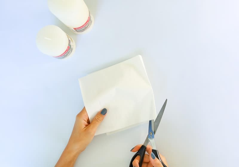 Razgrnite servieto in četrtino (en kvadrat) z lepilnim trakom prilepite na papir. 