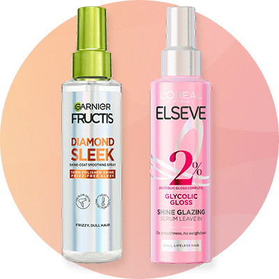 Eine silberne Tube mit der Aufschrift „Bali Curls Deep Repair Mask“ neben einer rosa Flasche „L'Oréal Elvital Glycolic Gloss“