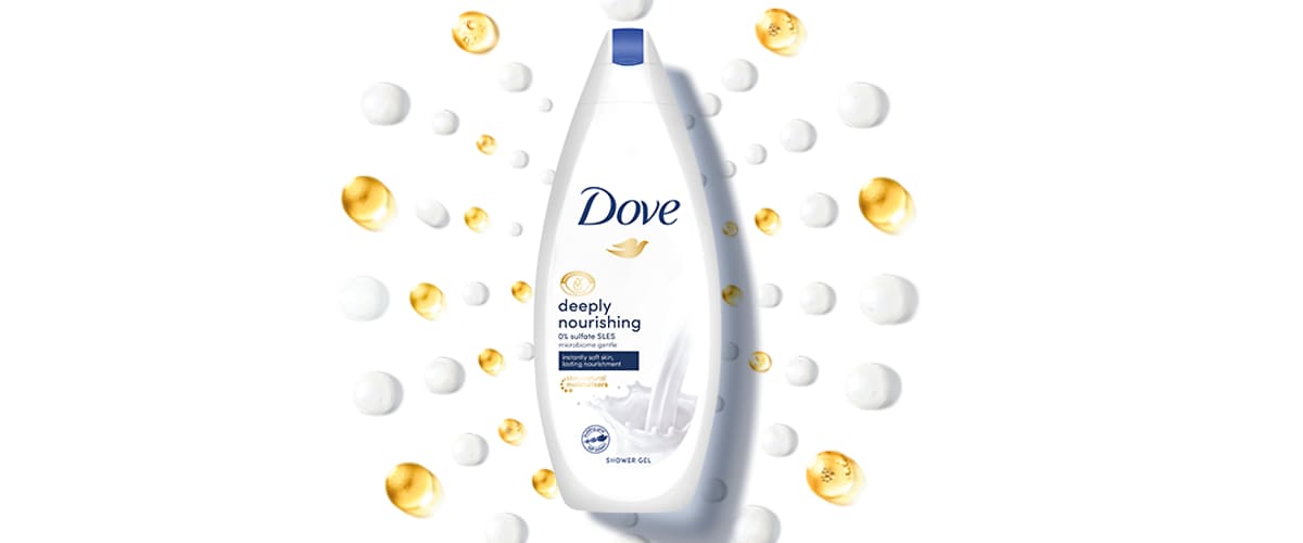 Slika koja prikazuje bocu Dove deeply nourishing tuš gela okruženu zlatnim i belim kapljicama