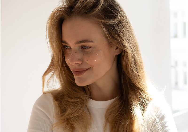 Junge Frau mit langen Haaren und silbernen Freckles